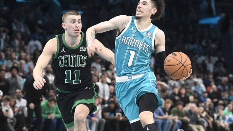 Nov 20, 2023; Charlotte, North Carolina, USA; Charlotte Hornets guard LaMelo Ball (1) drives past Boston Celtics guard Payton Pritchard (11) during the second half at the Spectrum Center. Mandatory Credit: Sam Sharpe-USA TODAY Sports