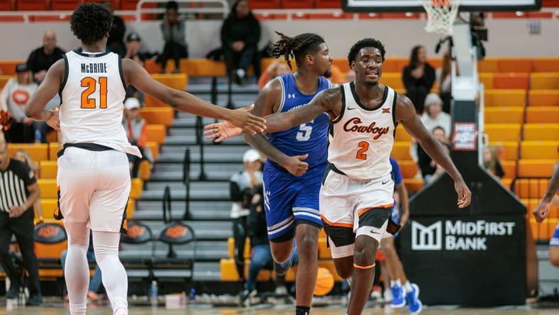 Nov 20, 2023; Stillwater, Oklahoma, USA; Oklahoma State Cowboys forward Justin McBride (21) and forward Eric Dailey Jr. (2) slap hands after a play during the second half against the New Orleans Privateers at Gallagher-Iba Arena. Mandatory Credit: William Purnell-USA TODAY Sports