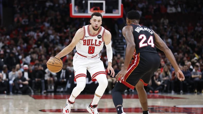Nov 20, 2023; Chicago, Illinois, USA; Chicago Bulls guard Zach LaVine (8) brings the ball up court against Miami Heat forward Haywood Highsmith (24) during the first half at United Center. Mandatory Credit: Kamil Krzaczynski-USA TODAY Sports