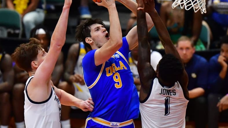 Nov 20, 2023; Honolulu, Hawaii, USA;  UCLA Bruins forward Berke Buyuktuncel (9) shoots the ball against Marquette Golden Eagles guard Kam Jones (1) during the first period at SimpliFi Arena at Stan Sheriff Center. Mandatory Credit: Steven Erler-USA TODAY Sports