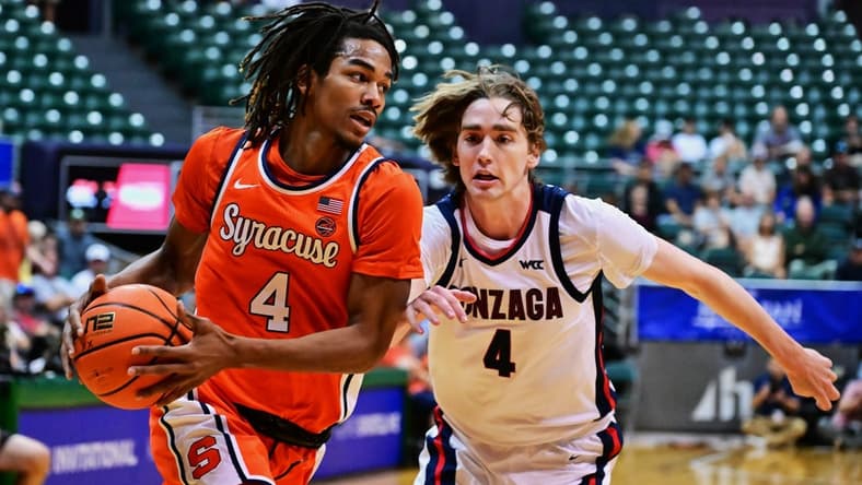 Nov 21, 2023; Honolulu, HI, USA;  Syracuse Orange forward Chris Bell (4) drives to the basket defended by Gonzaga Bulldogs guard Dusty Stromer (4) during the first period at SimpliFi Arena at Stan Sheriff Center. Mandatory Credit: Steven Erler-USA TODAY Sports