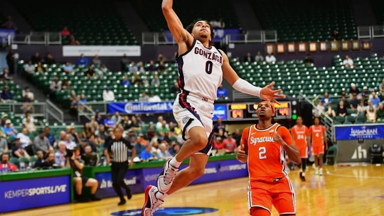 Nov 21, 2023; Honolulu, HI, USA;  Gonzaga Bulldogs guard Ryan Nembhard (0) drives to the basket as Syracuse Orange guard JJ Starling (2) looks on during the second half at SimpliFi Arena at Stan Sheriff Center. Mandatory Credit: Steven Erler-USA TODAY Sports