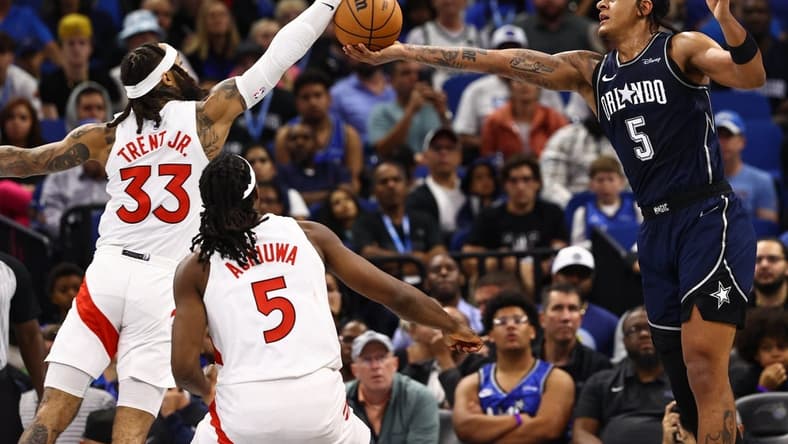 Nov 21, 2023; Orlando, Florida, USA; Toronto Raptors guard Gary Trent Jr. (33) and Orlando Magic forward Paolo Banchero (5) go after the basket during the second half at Amway Center. Mandatory Credit: Kim Klement Neitzel-USA TODAY Sports