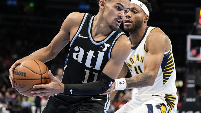 Nov 21, 2023; Atlanta, Georgia, USA; Atlanta Hawks guard Trae Young (11) tries to get past Indiana Pacers forward Bruce Brown (11) during the second half at State Farm Arena. Mandatory Credit: Dale Zanine-USA TODAY Sports