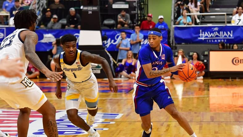 Nov 21, 2023; Honolulu, HI, USA; Kansas Jayhawks guard Dajuan Harris Jr. (3) drives the ball downcourt against Marquette Golden Eagles guard Kam Jones (1) and David Joplin (23) during the first period at SimpliFi Arena at Stan Sheriff Center. Mandatory Credit: Steven Erler-USA TODAY Sports