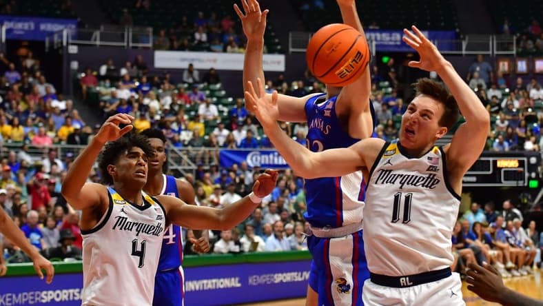 Nov 21, 2023; Honolulu, HI, USA; Kansas Jayhawks forward Parker Braun (23) fought for a rebound with Marquette Golden Eagles guard Stevie Mitchell (4) and guard Tyler Kolek (11) during the first period at SimpliFi Arena at Stan Sheriff Center. Mandatory Credit: Steven Erler-USA TODAY Sports