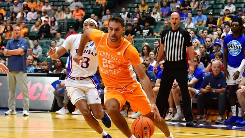 Nov 22, 2023; Honolulu, HI, USA;  Tennessee Volunteers guard Santiago Vescovi (25) drives around Kansas Jayhawks guard Dajuan Harris Jr. (3) during the first half at SimpliFi Arena at Stan Sheriff Center. Mandatory Credit: Steven Erler-USA TODAY Sports