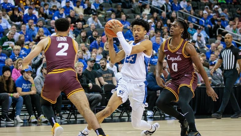 Nov 22, 2023; Kansas City, Missouri, USA; Creighton Bluejays guard Trey Alexander (23) looks for an opening during the first half between Loyola (Il) Ramblers guard Jalen Quinn (2) and Loyola (Il) Ramblers guard Desmond Watson (0) at T-Mobile Center. Mandatory Credit: William Purnell-USA TODAY Sports