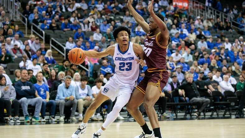 Nov 22, 2023; Kansas City, Missouri, USA; Creighton Bluejays guard Trey Alexander (23) drives around Loyola (Il) Ramblers forward Patrick Mwamba (30) during the first half at T-Mobile Center. Mandatory Credit: William Purnell-USA TODAY Sports