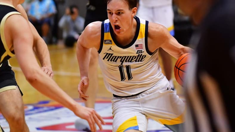 Nov 22, 2023; Honolulu, HI, USA; Marquette Golden Eagles guard Tyler Kolek (11) drives the ball down court defended by Purdue Boilermakers forward Camden Heide (23) during the second period at SimpliFi Arena at Stan Sheriff Center. Mandatory Credit: Steven Erler-USA TODAY Sports