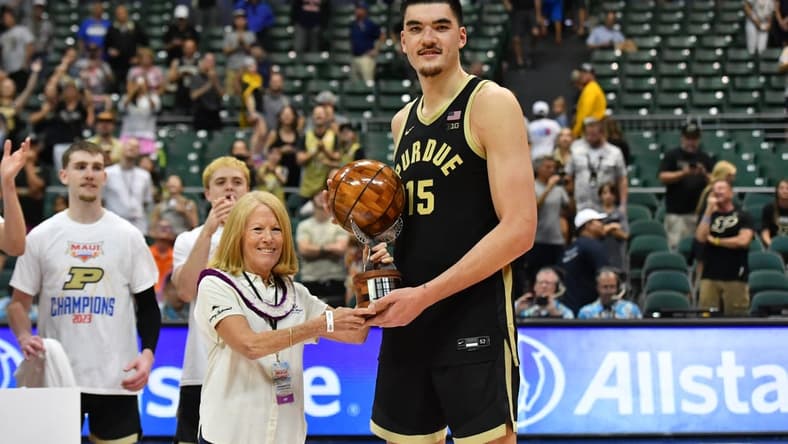 Nov 22, 2023; Honolulu, HI, USA; Purdue Boilermakers center Zach Edey (15) is presented the Most Valuable Player of the tournament by Chaminade University president Lynn Babington at SimpliFi Arena at Stan Sheriff Center. Mandatory Credit: Steven Erler-USA TODAY Sports