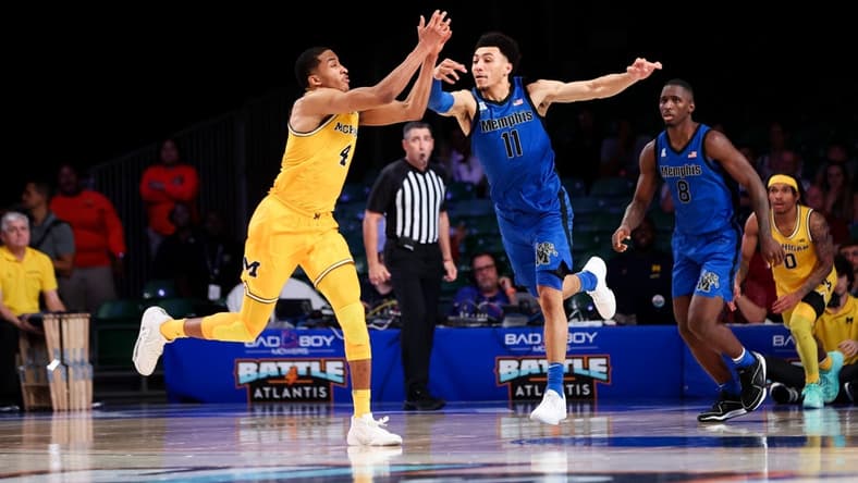 Nov 22, 2023; Paradise Island, BAHAMAS;  Michigan Wolverines guard Nimari Burnett (4) and Memphis Tigers guard Jahvon Quinerly (11) go for the ball during the second half at Imperial Arena. Mandatory Credit: Kevin Jairaj-USA TODAY Sports