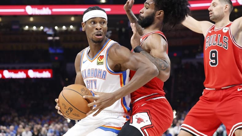 Nov 22, 2023; Oklahoma City, Oklahoma, USA; Oklahoma City Thunder guard Shai Gilgeous-Alexander (2) is defended by Chicago Bulls guard Coby White (0) on a drive to the basket during the second quarter at Paycom Center. Mandatory Credit: Alonzo Adams-USA TODAY Sports