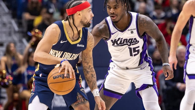 Nov 22, 2023; New Orleans, Louisiana, USA; New Orleans Pelicans guard Jose Alvarado (15) dribbles against Sacramento Kings guard Davion Mitchell (15) during the first half at the Smoothie King Center. Mandatory Credit: Stephen Lew-USA TODAY Sports