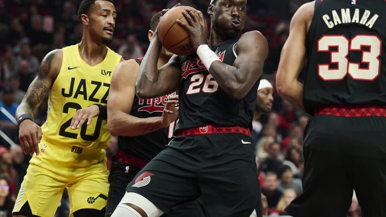 Nov 22, 2023; Portland, Oregon, USA; Portland Trail Blazers center Duop Reath (26) grabs an defensive rebound during the first half against the Utah Jazz at Moda Center. Mandatory Credit: Troy Wayrynen-USA TODAY Sports