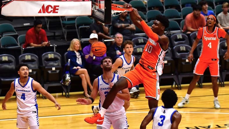 Nov 22, 2023; Honolulu, HI, USA; Syracuse Orange center Naheem McLeod (10) dunks the ball between defenders Chaminade Silverswords forward Wyatt Lowell (25) and forward Chris Bready (3) during the first period at SimpliFi Arena at Stan Sheriff Center. Mandatory Credit: Steven Erler-USA TODAY Sports