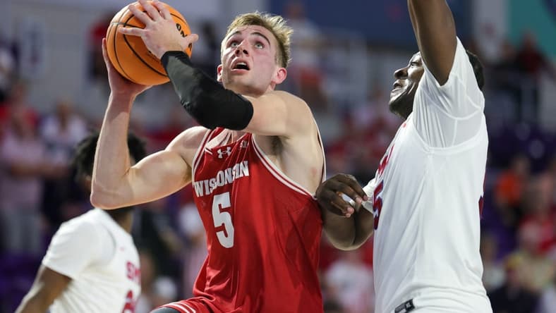 Nov 22, 2023; Fort Myers, FL, USA;  Wisconsin Badgers forward Tyler Wahl (5) drives tot the basket past Southern Methodist Mustangs forward Ja'Heim Hudson (15) in the second half during the Fort Myers Tip-Off championship game at Suncoast Credit Union Arena. Mandatory Credit: Nathan Ray Seebeck-USA TODAY Sports