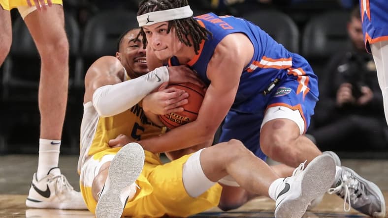 Nov 22, 2023; Brooklyn, New York, USA; Pittsburgh Panthers guard Ishmael Leggett (5) and Florida Gators guard Walter Clayton Jr. (1) battle for a loose ball in the second half at Barclays Center. Mandatory Credit: Wendell Cruz-USA TODAY Sports