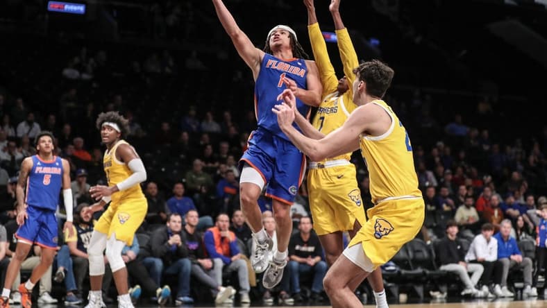 Nov 22, 2023; Brooklyn, New York, USA; Florida Gators guard Walter Clayton Jr. (1) drives past Pittsburgh Panthers guard Carlton Carrington (7) for a layup in the second half at Barclays Center. Mandatory Credit: Wendell Cruz-USA TODAY Sports