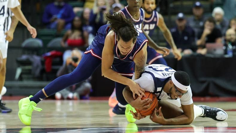 Nov 23, 2023; Kissimmee, Florida, USA;  Florida Atlantic Owls forward Tre Carroll (25) and Butler Bulldogs center Andre Screen (23) fight for a loose ball in the first half during the ESPN Events Invitational at State Farm Field House. Mandatory Credit: Nathan Ray Seebeck-USA TODAY Sports