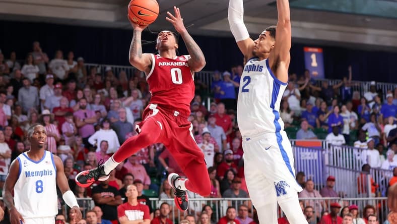 Nov 23, 2023; Paradise Island, BAHAMAS;  Arkansas Razorbacks guard Khalif Battle (0) shoots as Memphis Tigers forward Nick Jourdain (2) defends during the second half at Imperial Arena. Mandatory Credit: Kevin Jairaj-USA TODAY Sports