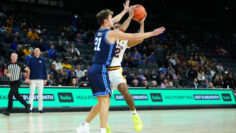 Nov 23, 2023; Las Vegas, Nevada, USA; Brigham Young Cougars guard Trevin Knell (21) defends against Arizona State Sun Devils guard Jose Perez (12) during the first half at Michelob Ultra Arena. Mandatory Credit: Stephen R. Sylvanie-USA TODAY Sports