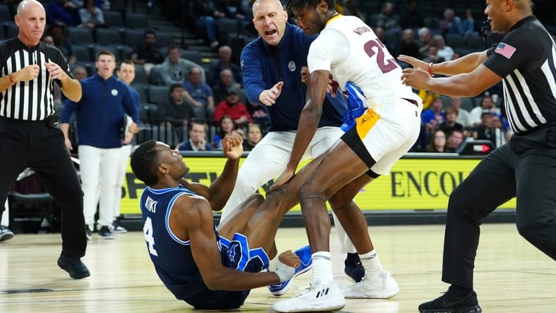 Nov 23, 2023; Las Vegas, Nevada, USA; Brigham Young Cougars head coach Mark Pope attempts to break up an altercation between Brigham Young Cougars forward Atiki Ally Atiki (4) and Arizona State Sun Devils forward Akil Watson (23) during the second half at Michelob Ultra Arena. Mandatory Credit: Stephen R. Sylvanie-USA TODAY Sports