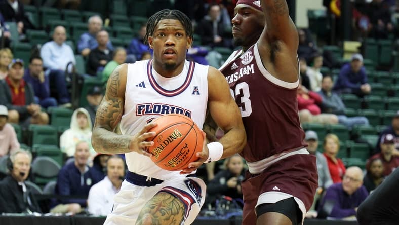 Nov 24, 2023; Kissimmee, FL, USA;Florida Atlantic Owls guard Alijah Martin (15) drives to the hoop guarded by Texas A&M Aggies guard Tyrece Radford (23) in the first half  during the ESPN Events Invitational Semifinals at State Farm Field House. Mandatory Credit: Nathan Ray Seebeck-USA TODAY Sports