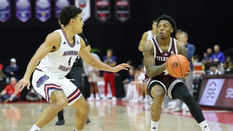 Nov 24, 2023; Kissimmee, FL, USA;  Texas A&M Aggies guard Wade Taylor IV (4) looks to shoot the ball guarded by Florida Atlantic Owls guard Bryan Greenlee (4) in the second half during the ESPN Events Invitational Semifinals at State Farm Field House. Mandatory Credit: Nathan Ray Seebeck-USA TODAY Sports