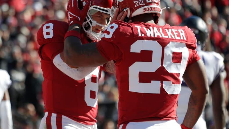 Nov 24, 2023; Norman, Oklahoma, USA; Oklahoma Sooners quarterback Dillon Gabriel (8) celebrates with running back Gavin Sawchuk (27) after a touchdown during the game against the TCU Horned Frogs at Gaylord Family-Oklahoma Memorial Stadium. Mandatory Credit: Bryan Terry-USA TODAY Sports
