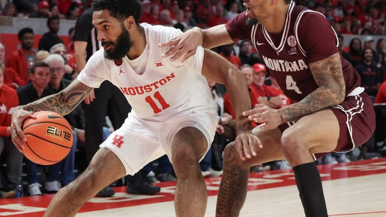 Nov 24, 2023; Houston, Texas, USA;  Houston Cougars guard Damian Dunn (11) dribbles against Montana Grizzlies guard Giordan Williams (4) in the first half at Fertitta Center. Mandatory Credit: Thomas Shea-USA TODAY Sports