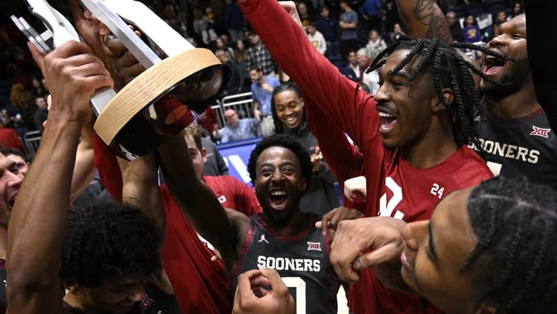 Nov 24, 2023; La Jolla, California, USA; Oklahoma Sooners players celebrate with the championship trophy after defeating USC Trojans at LionTree Arena. Mandatory Credit: Orlando Ramirez-USA TODAY Sports