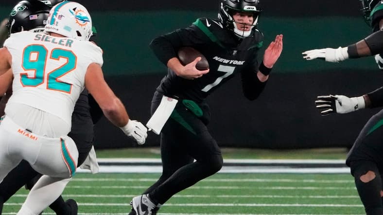 Nov 24, 2023; East Rutherford, New Jersey, USA; New York Jets quarterback Tim Boyle (7) scrambles against the Miami Dolphins in the second half at MetLife Stadium. Mandatory Credit: Robert Deutsch-USA TODAY Sports