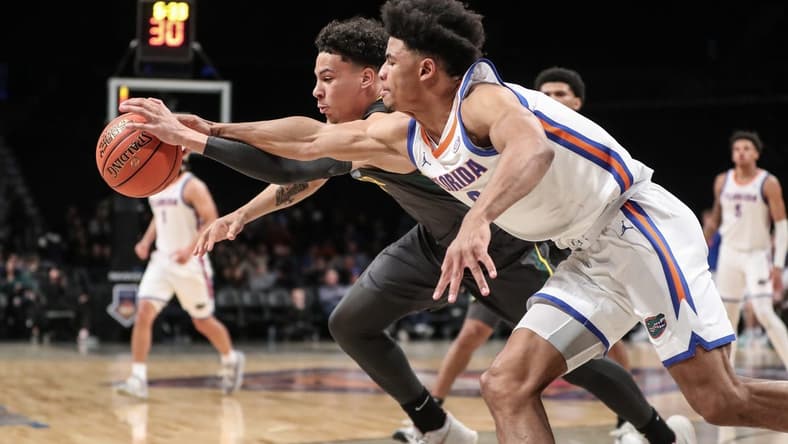 Nov 24, 2023; Brooklyn, NY, USA;  Florida Gators guard Zyon Pullin (0) and Baylor Bears guard Miro Little (1) fight for a loose ball in the first half at Barclay Center. Mandatory Credit: Wendell Cruz-USA TODAY Sports