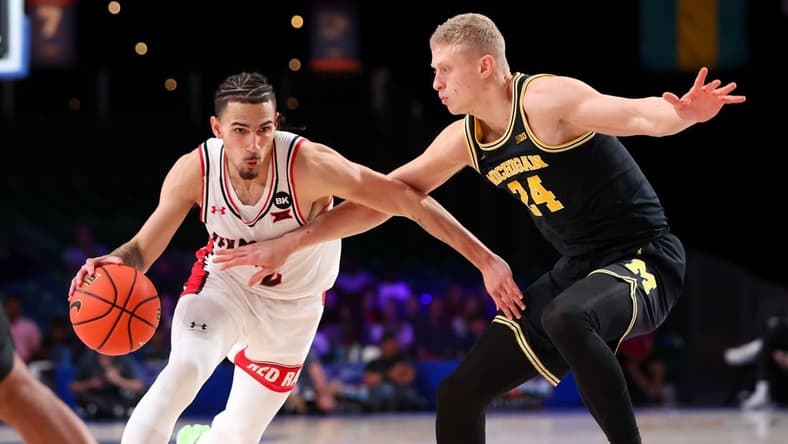 Nov 24, 2023; Paradise Island, BAHAMAS;  Texas Tech Red Raiders guard Pop Isaacs (2) drives to the basket as Michigan Wolverines forward Youssef Khayat (24) defends during the first half at Imperial Arena. Mandatory Credit: Kevin Jairaj-USA TODAY Sports