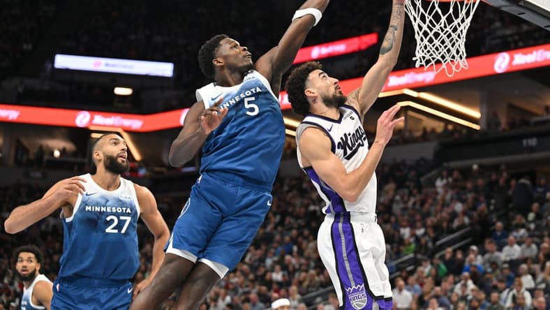 Nov 24, 2023; Minneapolis, Minnesota, USA; Minnesota Timberwolves guard Anthony Edwards (5) blocks the shot of Sacramento Kings guard Chris Duarte (3) as center Rudy Gobert (27) looks on during the first quarter at Target Center. Mandatory Credit: Jeffrey Becker-USA TODAY Sports