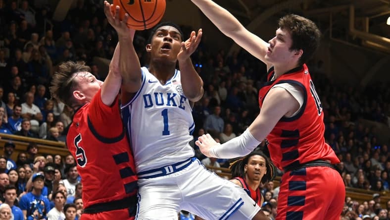 Nov 24, 2023; Durham, North Carolina, USA; Duke Blue Devils guard Caleb Foster (1) lays the ball up between Southern Indiana Screaming Eagles forward Jack Mielke (10) and guard Jack Campion (5) during the second half at Cameron Indoor Stadium. Mandatory Credit: Rob Kinnan-USA TODAY Sports