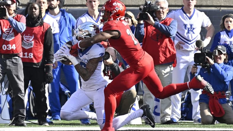 Nov 25, 2023; Louisville, Kentucky, USA; Kentucky Wildcats wide receiver Dane Key (6) catches a touchdown pass under the pressure of Louisville Cardinals defensive back Storm Duck (29) during the first half at L&N Federal Credit Union Stadium. Mandatory Credit: Jamie Rhodes-USA TODAY Sports