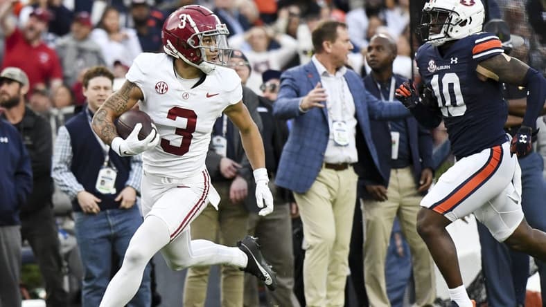 Nov 25, 2023; Auburn, Alabama, USA; Alabama Crimson Tide wide receiver Jermaine Burton (3) runs against Auburn Tigers safety Zion Puckett (10) for a touchdown at Jordan-Hare Stadium. Mandatory Credit: Gary Cosby Jr.-USA TODAY Sports