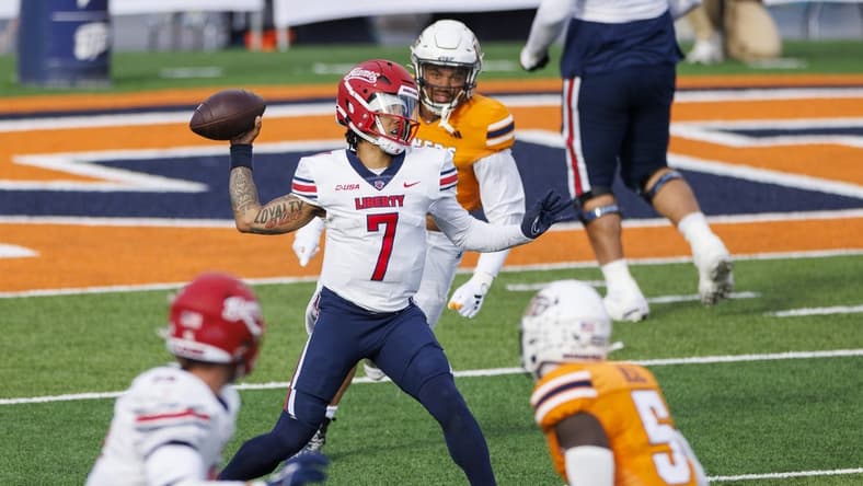 Nov 25, 2023; El Paso, Texas, USA; No. 22 Liberty Flames quarterback Kaidon Salter (7) tries throws the ball against the UTEP Miners defense during the first half at Sun Bowl Stadium. Mandatory Credit: Ivan Pierre Aguirre-USA TODAY Sports