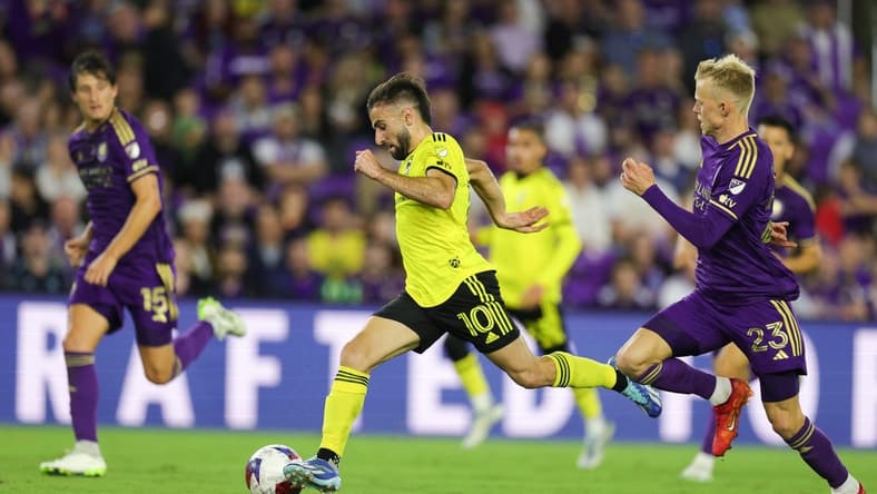 Nov 25, 2023; Orlando, Florida, USA; Columbus Crew forward Diego Rossi (10) dribbles the ball as Orlando City midfielder Dagur Dan Thorhallsson (23) defends during the second half in a MLS Cup Eastern Conference Semifinal match at Exploria Stadium. Mandatory Credit: Nathan Ray Seebeck-USA TODAY Sports