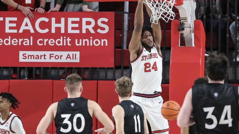 Nov 25, 2023; Queens, New York, USA; St. John's Red Storm forward Zuby Ejiofor (24) dunks in the first half against the Holy Cross Crusaders at Carnesecca Arena. Mandatory Credit: Wendell Cruz-USA TODAY Sports