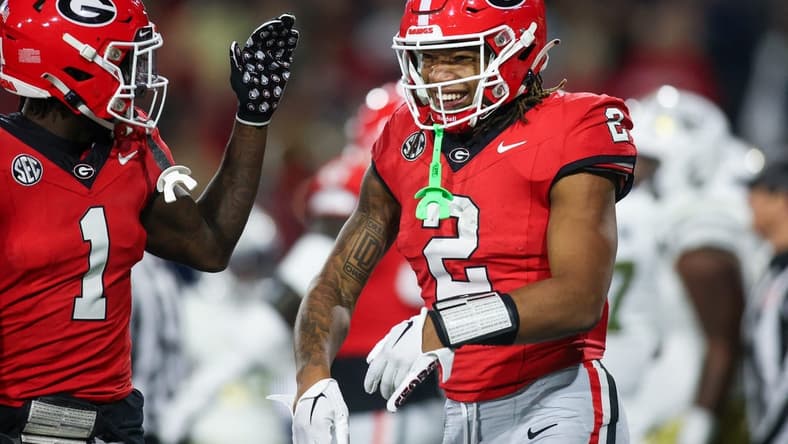 Nov 25, 2023; Atlanta, Georgia, USA; Georgia Bulldogs running back Kendall Milton (2) celebrates with wide receiver Marcus Rosemy-Jacksaint (1) after a touchdown against the Georgia Tech Yellow Jackets in the second quarter at Bobby Dodd Stadium at Hyundai Field. Mandatory Credit: Brett Davis-USA TODAY Sports