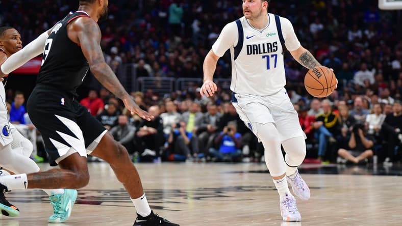 Nov 25, 2023; Los Angeles, California, USA; Dallas Mavericks guard Luka Doncic (77) controls the ball against the Los Angeles Clippers during the second half Crypto.com Arena. Mandatory Credit: Gary A. Vasquez-USA TODAY Sports