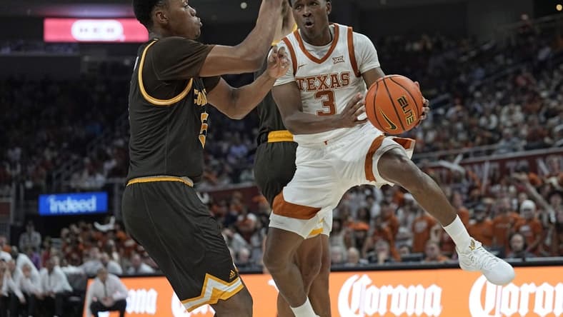 Nov 26, 2023; Austin, Texas, USA; Texas Longhorns guard Max Abmas (3) passes the ball while defended by Wyoming Cowboys forward Cam Manyawu (5) during the first half at Moody Center. Mandatory Credit: Scott Wachter-USA TODAY Sports