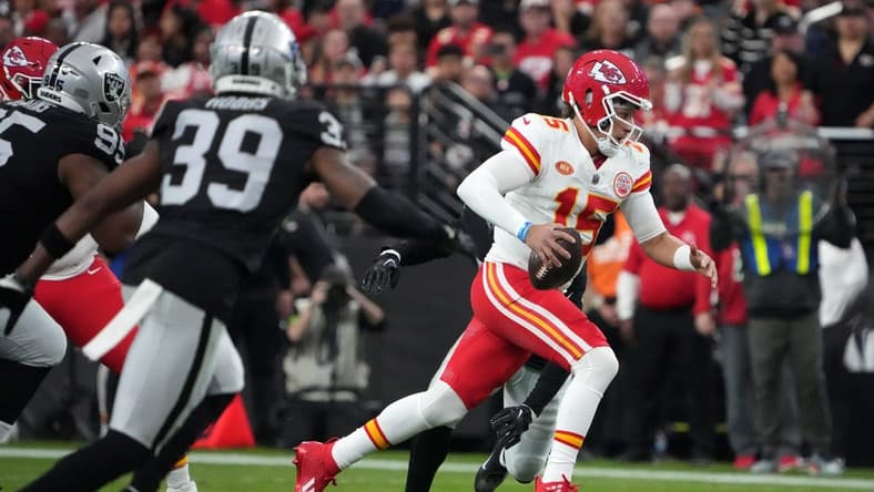 Nov 26, 2023; Paradise, Nevada, USA; Kansas City Chiefs quarterback Patrick Mahomes (15) carries the ball against the Las Vegas Raiders in the first half at Allegiant Stadium. Mandatory Credit: Kirby Lee-USA TODAY Sports