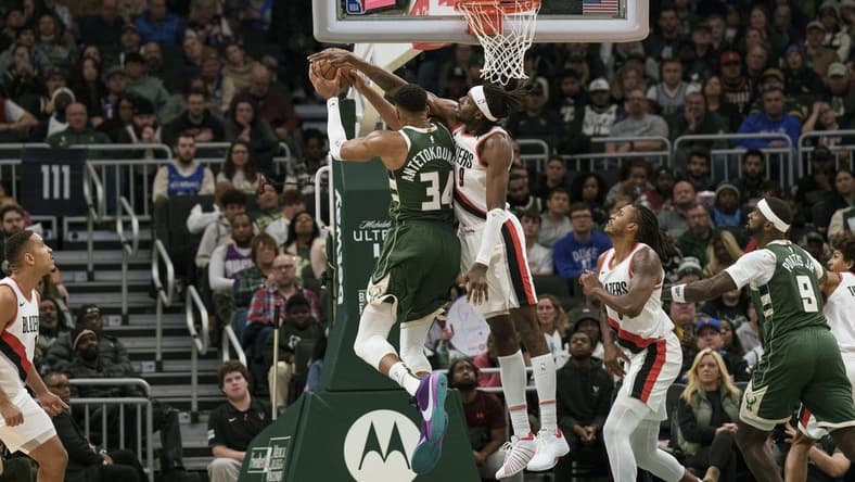 Nov 26, 2023; Milwaukee, Wisconsin, USA;  Portland Trail Blazers forward Jerami Grant (9) defends Milwaukee Bucks forward Giannis Antetokounmpo (34) during the fourth quarter at Fiserv Forum. Mandatory Credit: Jeff Hanisch-USA TODAY Sports