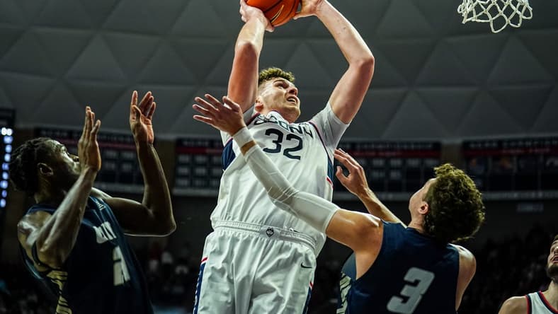 Nov 27, 2023; Storrs, Connecticut, USA; UConn Huskies center Donovan Clingan (32) shoots against New Hampshire Wildcats forward Jaxson Baker (3) in the first half at Harry A. Gampel Pavilion. Mandatory Credit: David Butler II-USA TODAY Sports