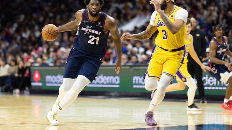 Nov 27, 2023; Philadelphia, Pennsylvania, USA; Philadelphia 76ers center Joel Embiid (21) dribbles the ball against Los Angeles Lakers forward Anthony Davis (3) during the third quarter at Wells Fargo Center. Mandatory Credit: Bill Streicher-USA TODAY Sports