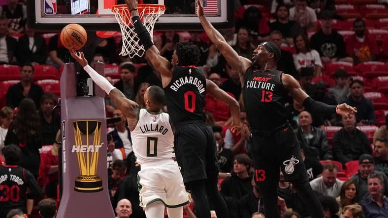 Nov 28, 2023; Miami, Florida, USA; Milwaukee Bucks guard Damian Lillard (0) puts up a shot against Miami Heat guard Josh Richardson (0) during the first half at Kaseya Center. Mandatory Credit: Jasen Vinlove-USA TODAY Sports